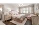 Bright bedroom with a large window, plush carpeting, and a cozy armchair with tufted headboard at 301 Abercorn Sq, Peachtree City, GA 30269