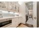 Charming butler's pantry with white cabinets, stainless steel appliances and hardwood floors at 301 Abercorn Sq, Peachtree City, GA 30269