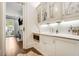 Bright butler's pantry with white cabinets and a stainless steel microwave at 301 Abercorn Sq, Peachtree City, GA 30269
