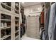 Organized closet with shelving, drawers, hanging racks and light wood-grain finish at 301 Abercorn Sq, Peachtree City, GA 30269