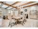 Dining area features a wood table, upholstered chairs, tile floors and exposed wooden beams at 301 Abercorn Sq, Peachtree City, GA 30269