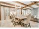 Dining area features a wood table, upholstered chairs, tile floors and exposed wooden beams at 301 Abercorn Sq, Peachtree City, GA 30269