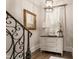 Inviting entryway features hardwood floors, decorative chest, stylish lighting, and a framed mirror at 301 Abercorn Sq, Peachtree City, GA 30269