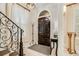 A foyer with a dark wood front door, staircase with iron railing and chandelier at 301 Abercorn Sq, Peachtree City, GA 30269
