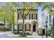 Elegant two-story home showcasing dark shutters, symmetrical windows and mature trees at 301 Abercorn Sq, Peachtree City, GA 30269