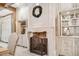 Elegant fireplace with stone mantle flanked by custom cabinets with glass displays at 301 Abercorn Sq, Peachtree City, GA 30269