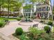 Charming neighborhood fountain surrounded by lush landscaping and benches for enjoying the outdoors at 301 Abercorn Sq, Peachtree City, GA 30269