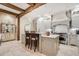 Gourmet kitchen featuring a large island, wooden beams, and stainless-steel appliances at 301 Abercorn Sq, Peachtree City, GA 30269