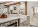 Kitchen island with built-in microwave, farmhouse sink, marble countertops, and chrome faucet at 301 Abercorn Sq, Peachtree City, GA 30269
