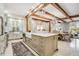 Spacious kitchen with a large center island, wooden beams, and open layout dining area at 301 Abercorn Sq, Peachtree City, GA 30269