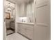 Clean laundry room with white cabinetry, sink, and modern washer and dryer set at 301 Abercorn Sq, Peachtree City, GA 30269