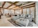 Bright open-concept features tile floors, decorative ceiling beams, and views into kitchen and dining area at 301 Abercorn Sq, Peachtree City, GA 30269
