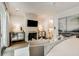 Open-concept living room with modern decor, a fireplace, and a view to an ensuite at 301 Abercorn Sq, Peachtree City, GA 30269