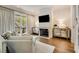 Bright living room with a fireplace, hardwood floors, and elegant decor at 301 Abercorn Sq, Peachtree City, GA 30269