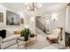 Stylish living room with neutral tones, decorative chandelier, and an open view of the staircase at 301 Abercorn Sq, Peachtree City, GA 30269