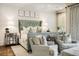 Serene main bedroom boasts plush seating, crown molding, and ample natural light at 301 Abercorn Sq, Peachtree City, GA 30269