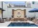 A luxurious backyard pool with a fountain and elegant seating area, perfect for relaxing and entertaining outdoors at 301 Abercorn Sq, Peachtree City, GA 30269