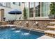 A refreshing pool with lion head fountains and a nearby patio, perfect for relaxation and outdoor enjoyment at 301 Abercorn Sq, Peachtree City, GA 30269