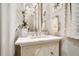 Elegant powder room with marble vanity, designer fixtures, and decorative accents at 301 Abercorn Sq, Peachtree City, GA 30269
