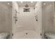 Modern shower with dual shower heads, built-in bench, white tile, and glass doors at 301 Abercorn Sq, Peachtree City, GA 30269
