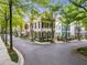 A picturesque street featuring elegant homes with manicured lawns and tree-lined sidewalks at 301 Abercorn Sq, Peachtree City, GA 30269