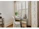Vanity with decorative chair, mirror, and window with natural light at 301 Abercorn Sq, Peachtree City, GA 30269
