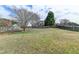 Expansive backyard with a tree and a wooden privacy fence at 312 Jodeco Station E Cir, Stockbridge, GA 30281