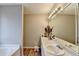 Bathroom featuring double sinks, large mirror, and wood-style floors at 312 Jodeco Station E Cir, Stockbridge, GA 30281