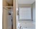 Bathroom featuring a bathtub, shower, and window at 312 Jodeco Station E Cir, Stockbridge, GA 30281
