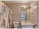 Bathroom featuring a toilet, sink, and shower with curtain at 312 Jodeco Station E Cir, Stockbridge, GA 30281