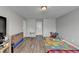 Bedroom with wood-look flooring has a twin bed with a plaid spread, and grey paint at 312 Jodeco Station E Cir, Stockbridge, GA 30281