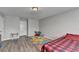 Bedroom with wood-look floors features a twin bed with a plaid bedspread and grey paint at 312 Jodeco Station E Cir, Stockbridge, GA 30281