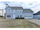 Two-story home with a blue facade, attached two-car garage and manicured front yard at 312 Jodeco Station E Cir, Stockbridge, GA 30281
