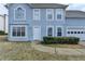 Two-story home with a blue facade, attached two-car garage and manicured front yard at 312 Jodeco Station E Cir, Stockbridge, GA 30281