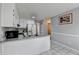 Bright kitchen with white cabinets, stainless steel sink, and a view into another room at 312 Jodeco Station E Cir, Stockbridge, GA 30281