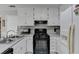 Kitchen featuring white cabinets and a black gas range at 312 Jodeco Station E Cir, Stockbridge, GA 30281