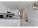 Bright kitchen with white cabinets, stainless steel sink, and a view into another room at 312 Jodeco Station E Cir, Stockbridge, GA 30281