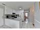 Bright kitchen with white cabinets, stainless steel sink, and a view into another room at 312 Jodeco Station E Cir, Stockbridge, GA 30281