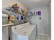 Laundry room with white washer and dryer and wire shelving at 312 Jodeco Station E Cir, Stockbridge, GA 30281