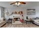 Spacious living room featuring a fireplace, ceiling fan and wood laminate flooring throughout at 312 Jodeco Station E Cir, Stockbridge, GA 30281