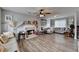 Spacious living room with ceiling fan, fireplace, and wood laminate flooring throughout at 312 Jodeco Station E Cir, Stockbridge, GA 30281