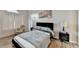Well-lit main bedroom with wood-look flooring and neutral decor at 312 Jodeco Station E Cir, Stockbridge, GA 30281