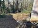 The backyard slopes down from the house to the woods and is accessible via concrete steps at 1255 North Nw Ave, Atlanta, GA 30318