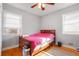 Cozy bedroom with hardwood floors, two windows, and classic wood-frame bed at 1255 North Nw Ave, Atlanta, GA 30318
