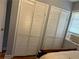 Bedroom features louvered closet doors and a window with blinds at 1255 North Nw Ave, Atlanta, GA 30318