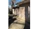 Side view of the home featuring brick exterior and concrete driveway, with a lush backyard at 1255 North Nw Ave, Atlanta, GA 30318