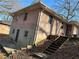 Two-story brick home showcasing a side view with a backyard entrance and a partial basement entrance at 1255 North Nw Ave, Atlanta, GA 30318