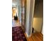 Hallway with hardwood floors, colorful rug, and an open view of the basement steps at 1255 North Nw Ave, Atlanta, GA 30318