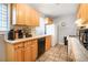 Well-lit kitchen featuring tile floors, wood cabinets, modern appliances, and a window view at 1255 North Nw Ave, Atlanta, GA 30318