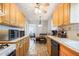 Traditional eat-in kitchen featuring wood cabinets, tile backsplash, and updated appliances at 1255 North Nw Ave, Atlanta, GA 30318
